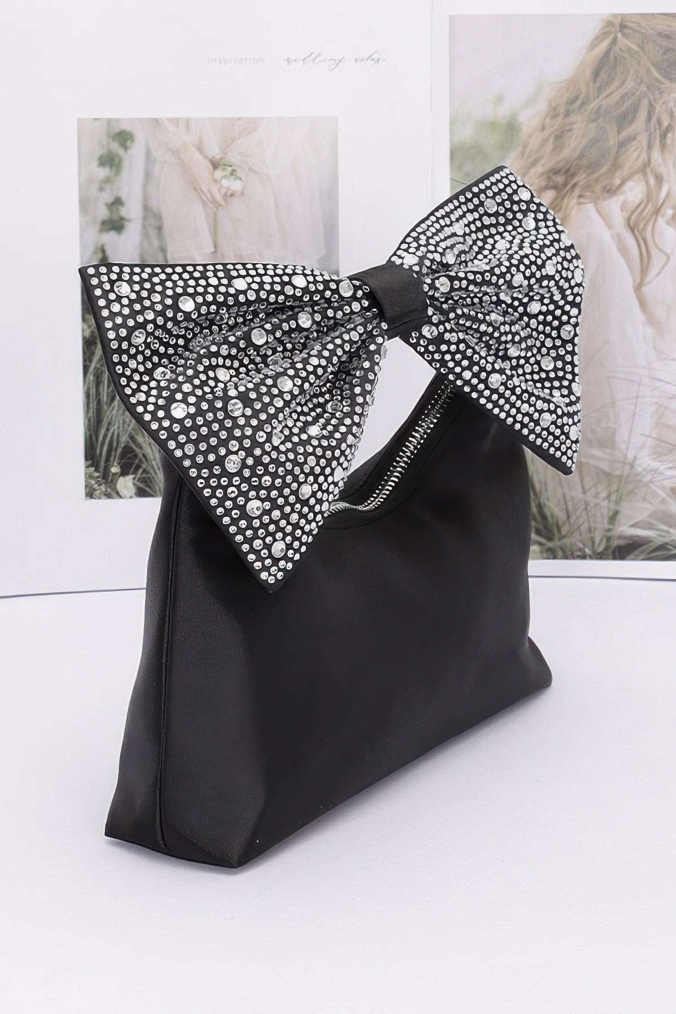 Black nylon clutch with crystal-studded rhinestone bow handle