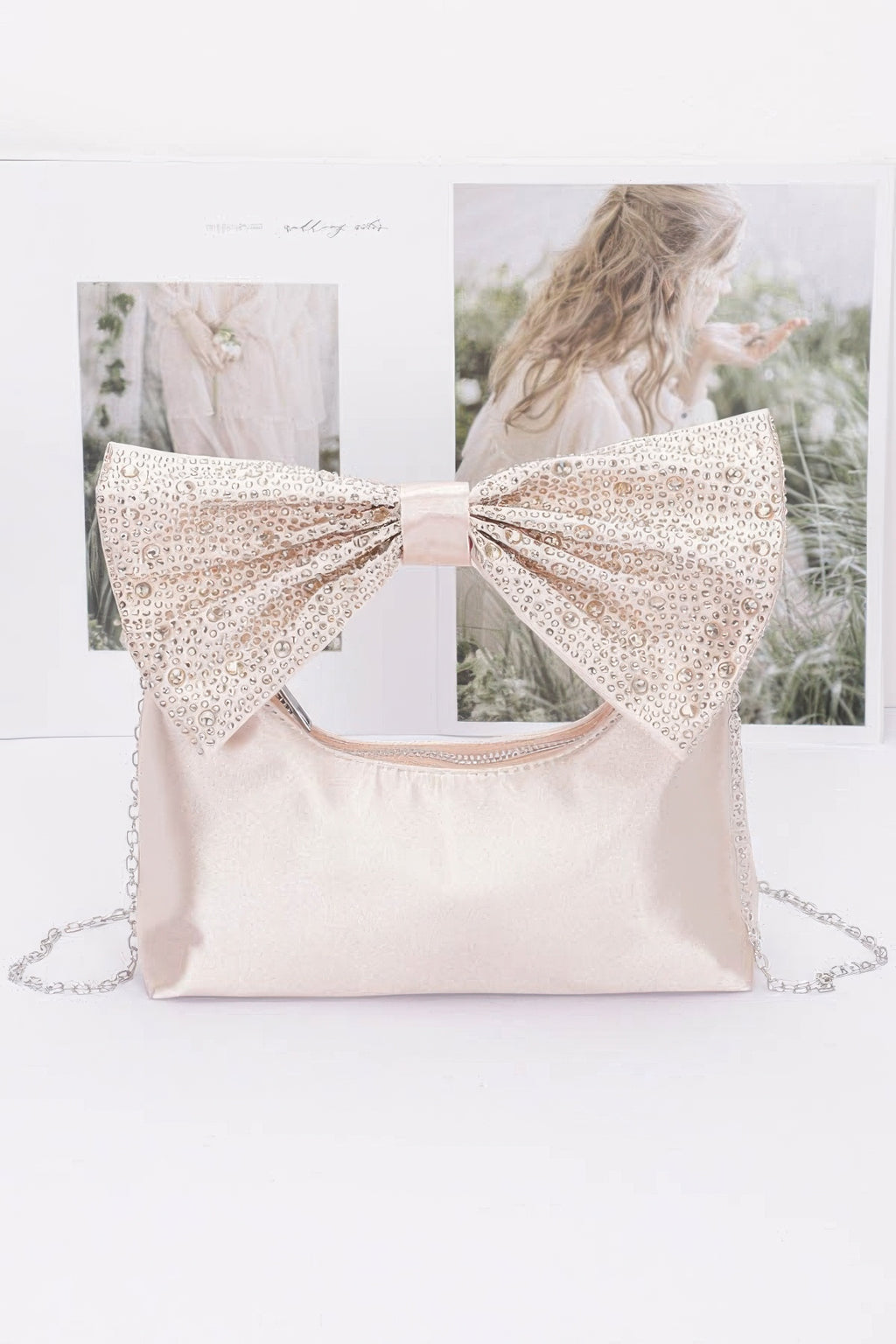 Light pink/cream nylon clutch with rhinestone bow handle and chain strap
