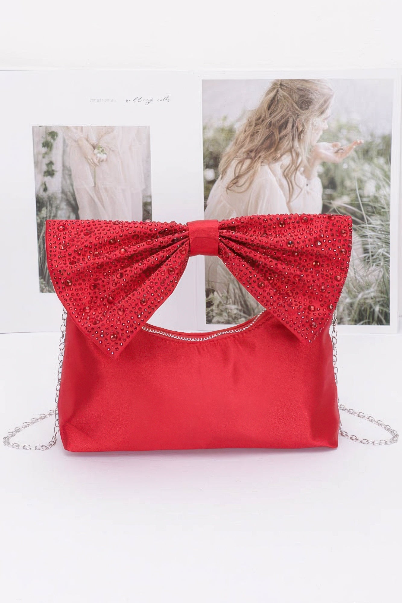 Red nylon clutch with rhinestone bow handle and chain strap