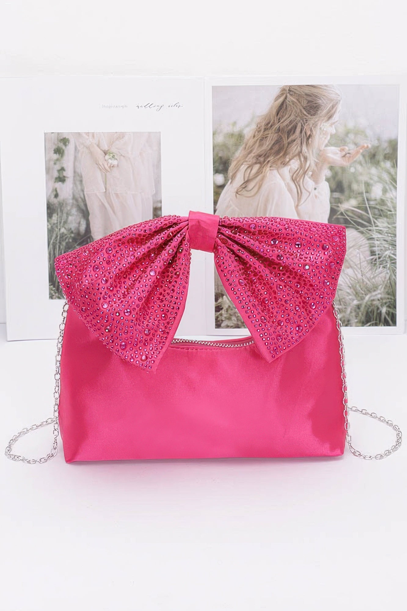 Fuchsia nylon clutch with rhinestone bow handle and chain strap