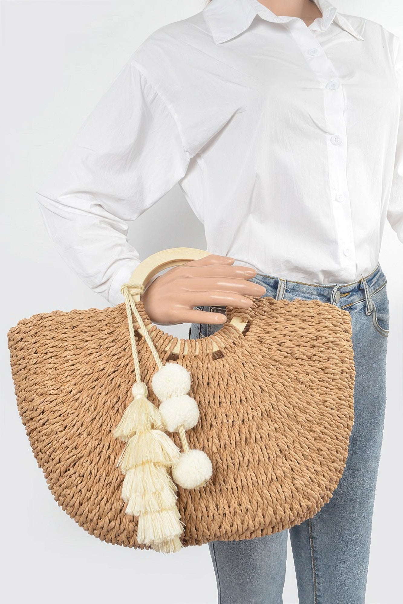 Woven cotton tote bag with curved wood handle and tassel pom‑poms, khaki