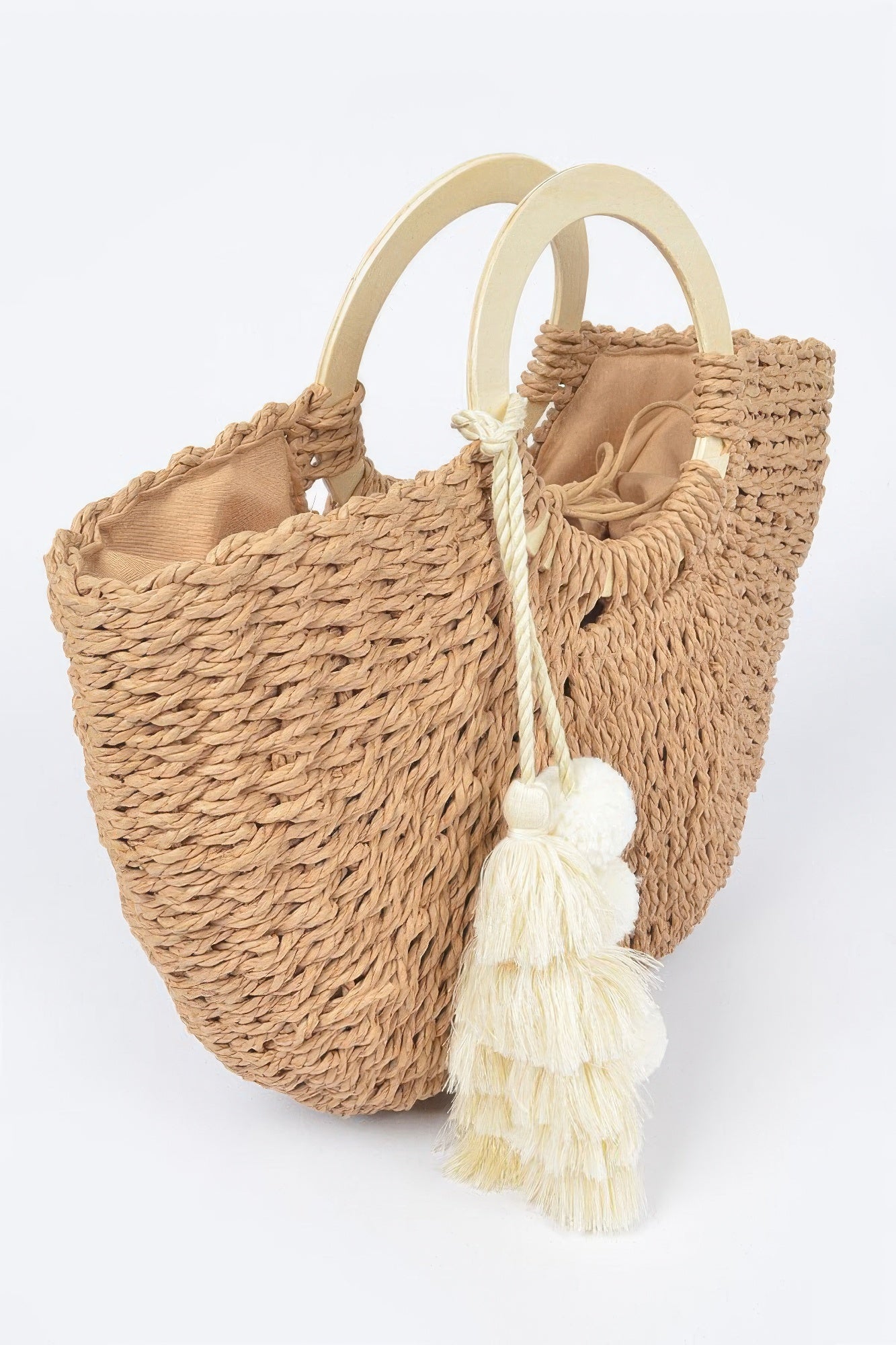 Woven cotton tote bag with double wood handles, tassel pom‑poms, khaki