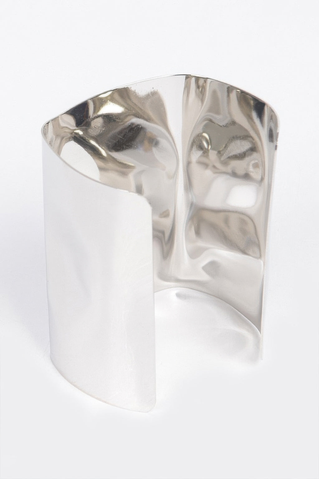 Silver-tone metal cuff bracelet with wide open profile and smooth polished texture