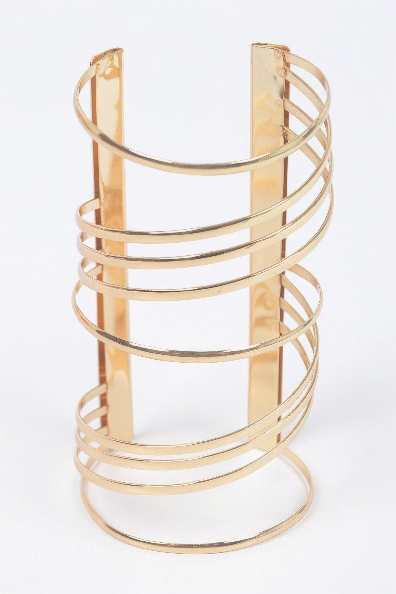 Gold cuff bracelet with wide vertical plate and multiple horizontal metal loops