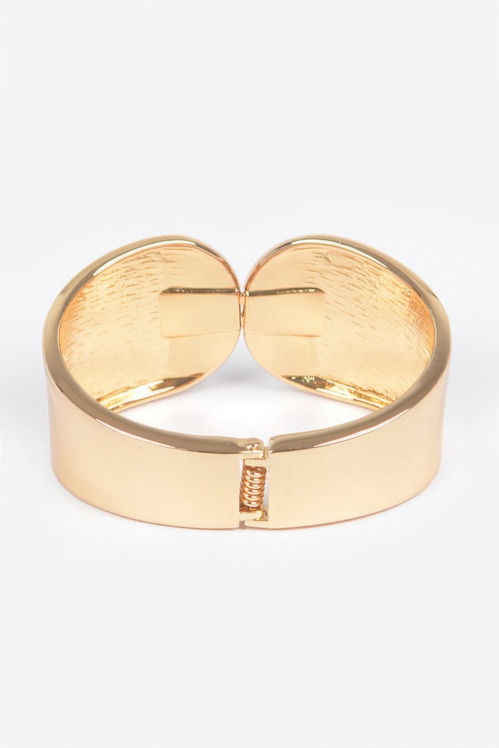 Gold metal spring hinge cuff bracelet, front hinge and clasp centered