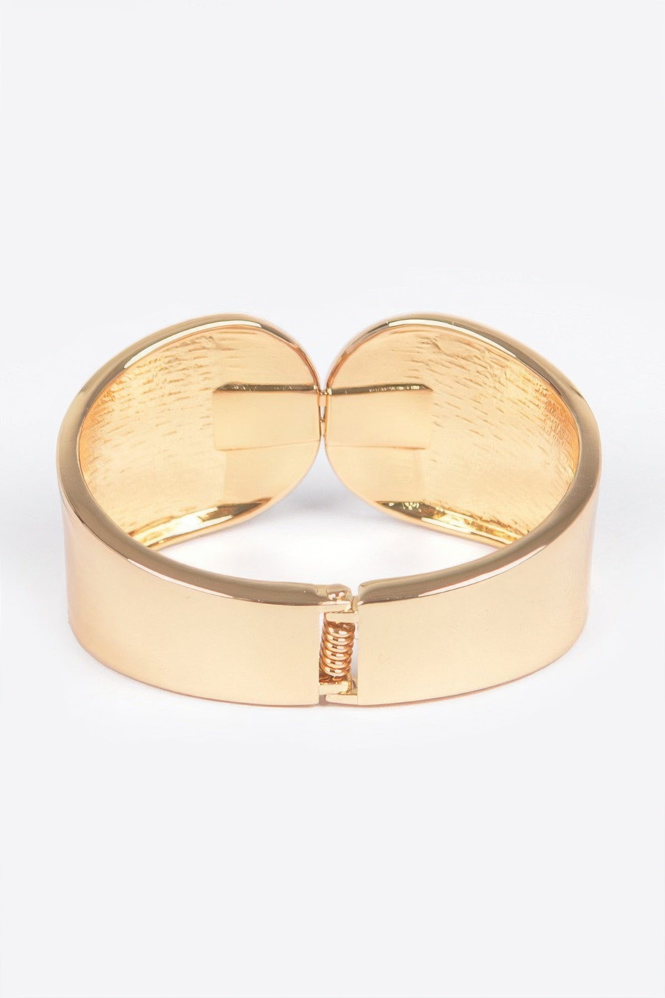 Gold metal spring hinge cuff bracelet, front hinge and clasp centered