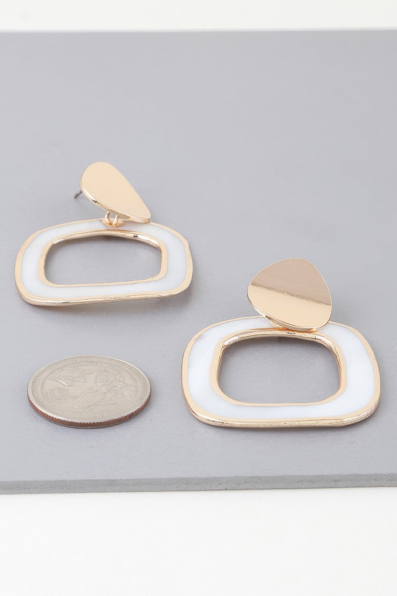 Large abstract marble frame earrings in gold-cream; teardrop tops, oval frames