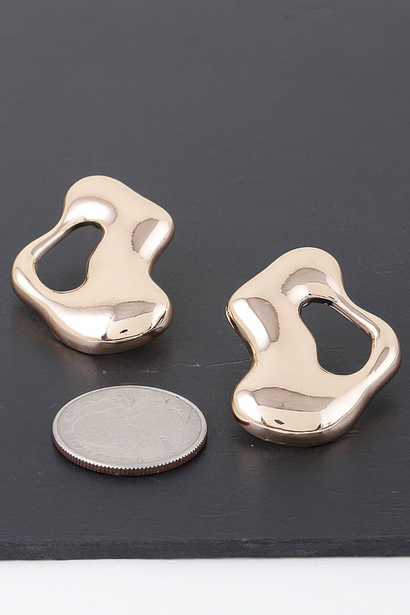Abstract Modern Puddle Earrings, gold-tone sculpted open shape, close view of one earring