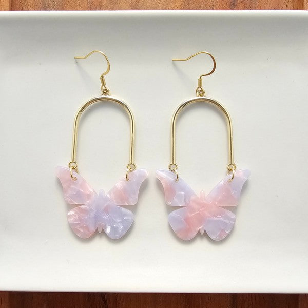 Enchanted butterfly earrings with gold arches and pale pink layered butterfly charms