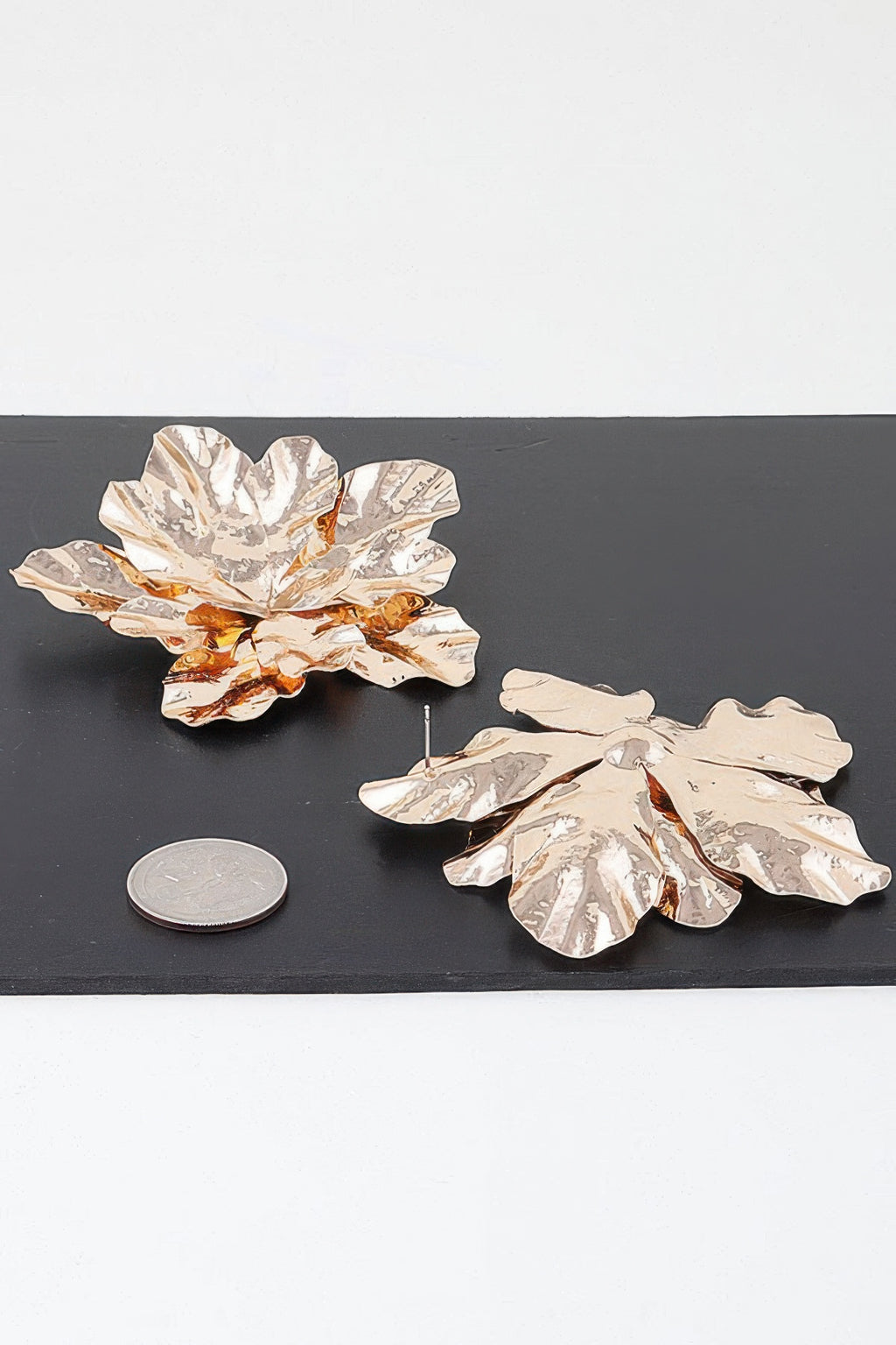 Gold maple leaf earrings with textured leaf cutouts and slender hanging wire