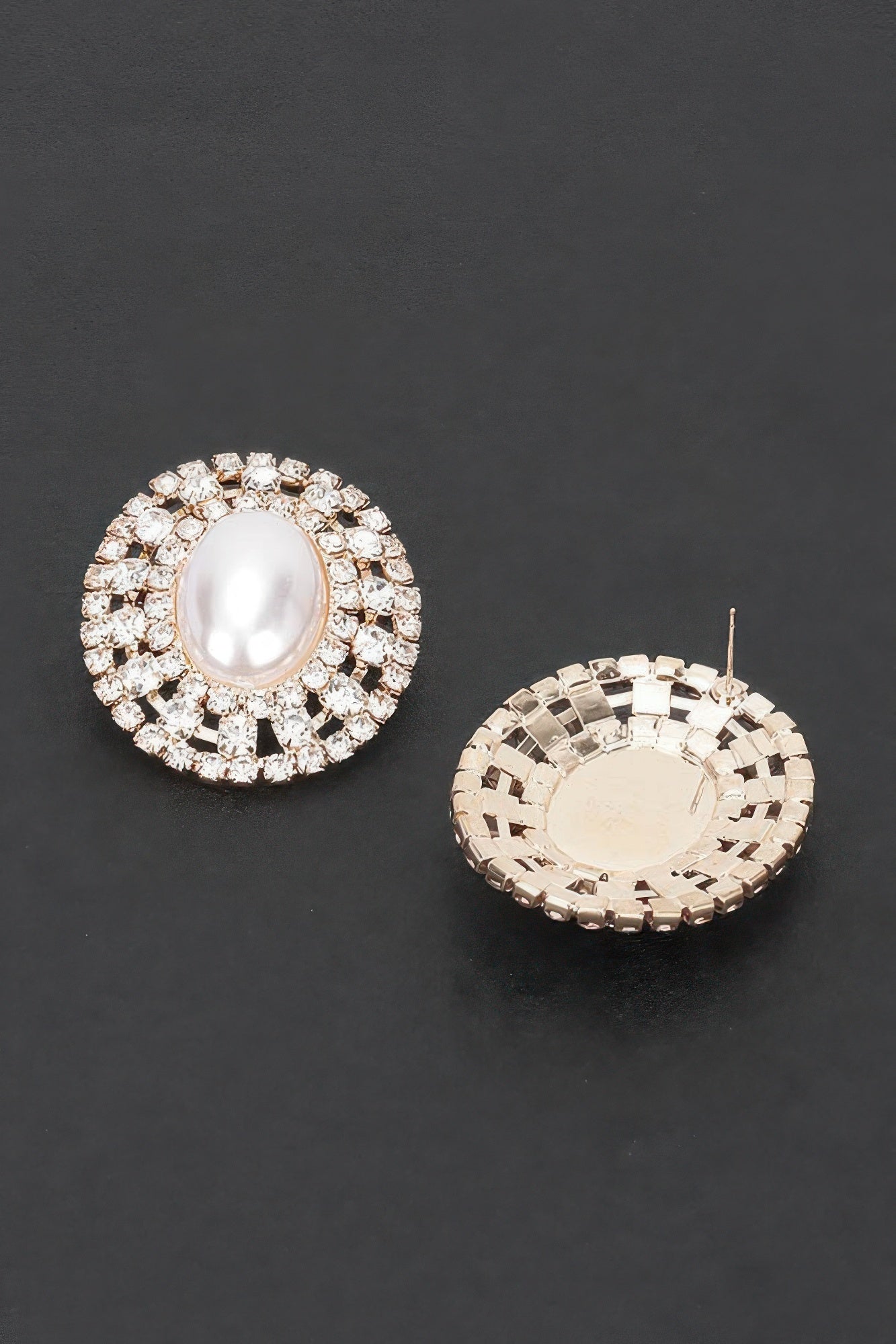 Faux pearl rhinestone stud earring with oval center; back shows gold-tone clasp