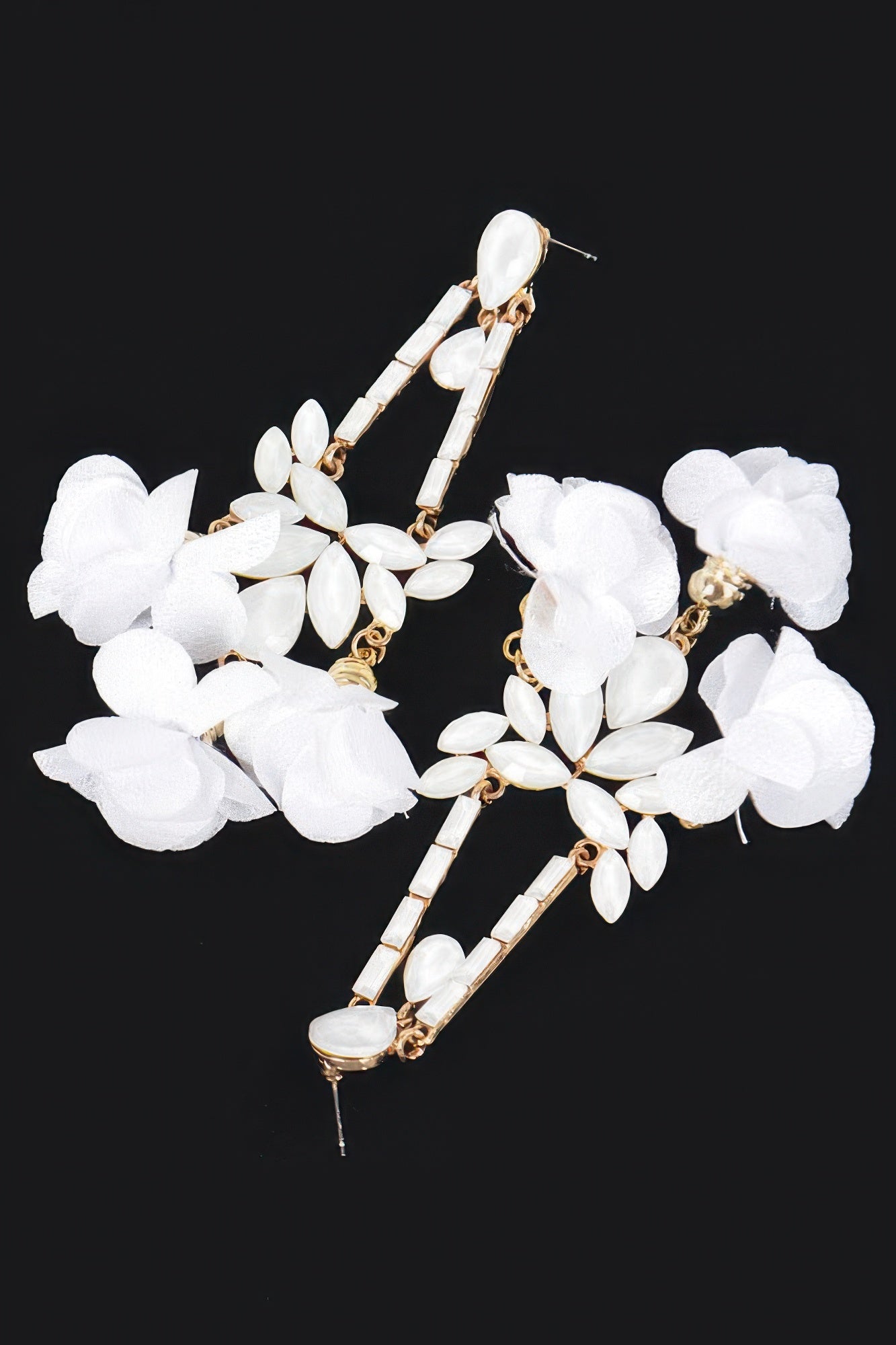 White flower statement earrings with layered petal clusters and gold-tone bar dangles