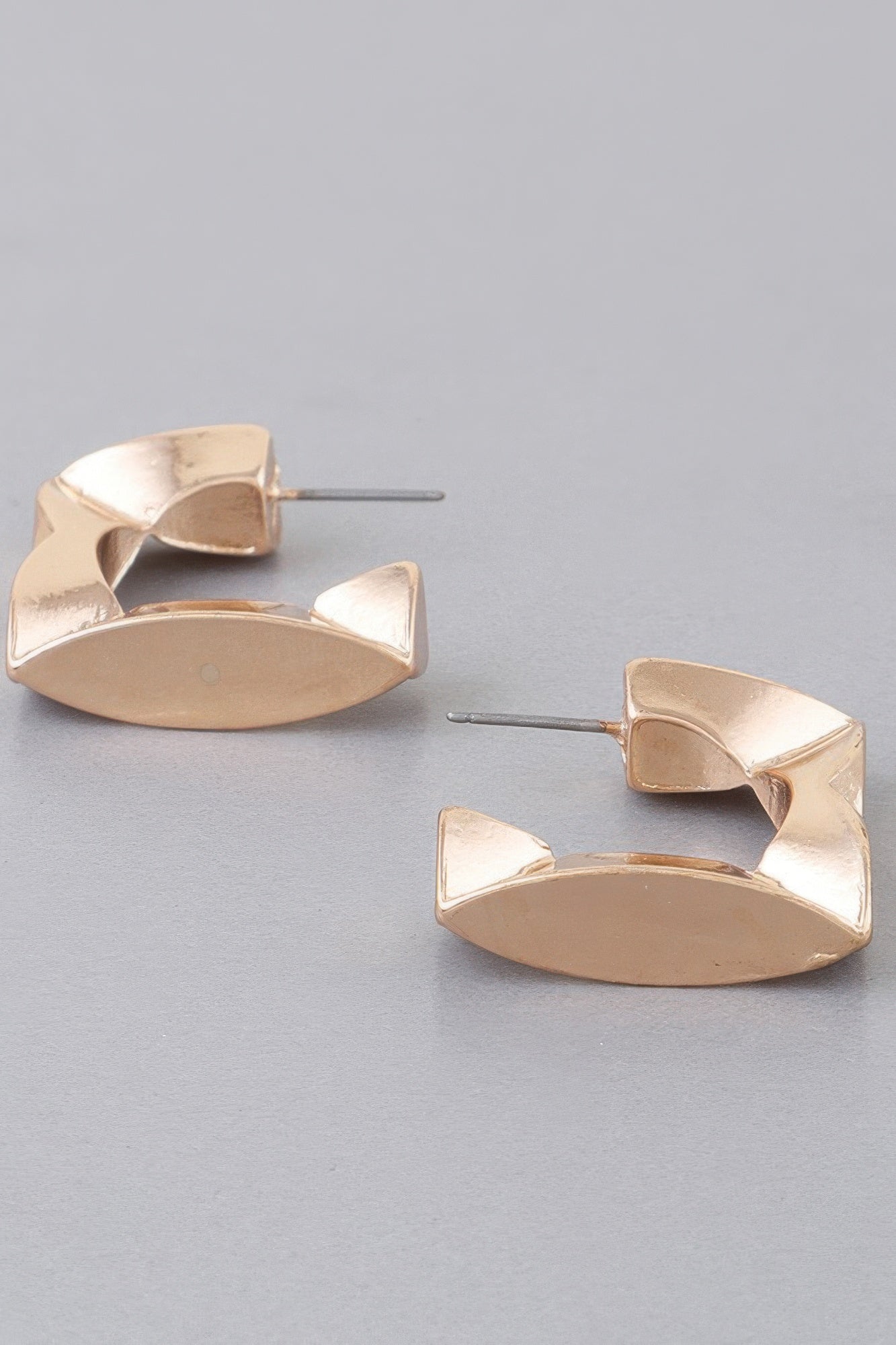 Gold geometric cubic hoop earrings, flat faceted square sections with post backs.