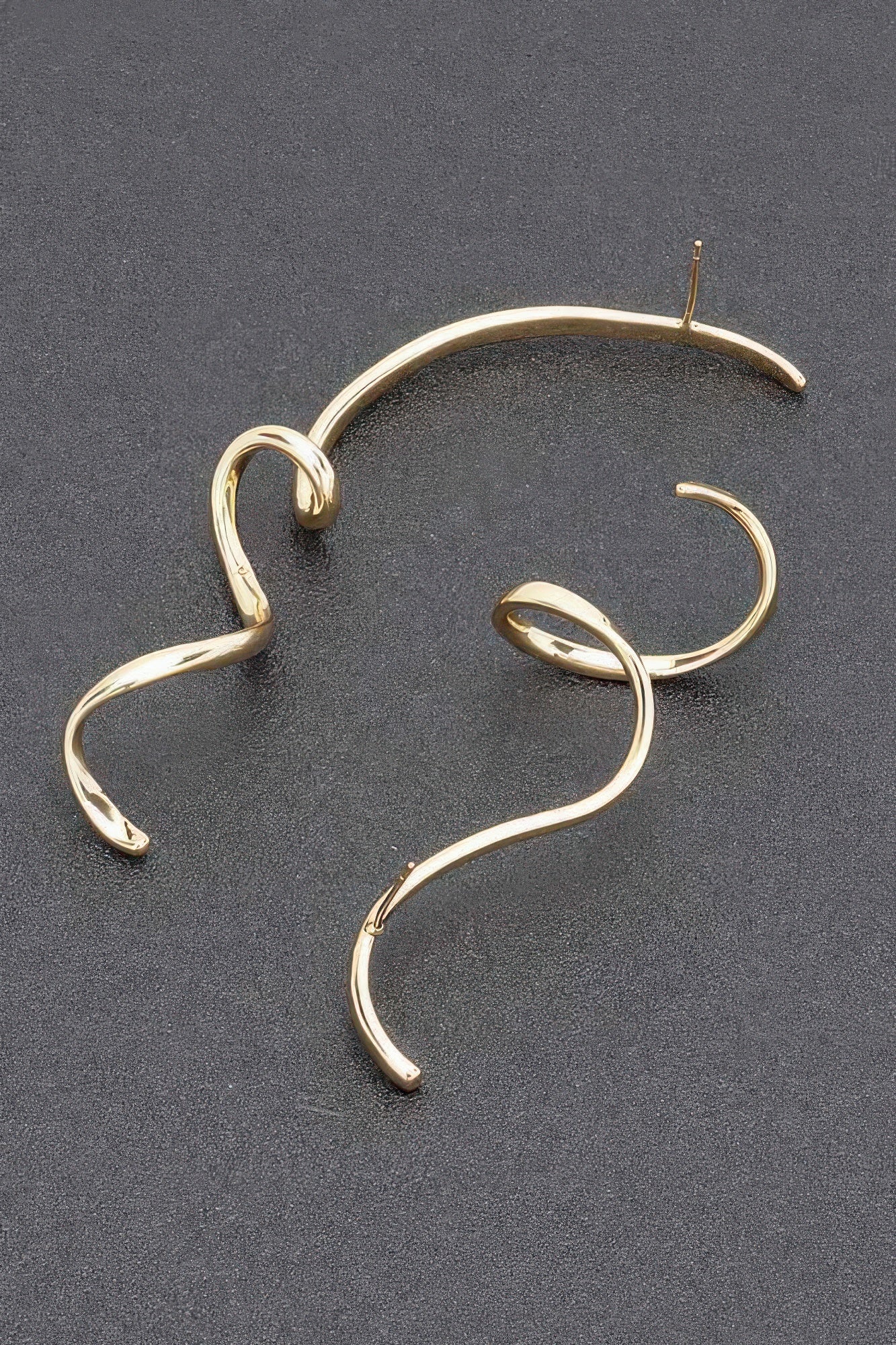 Gold plated twisted dangle earrings with looped metal hoop design