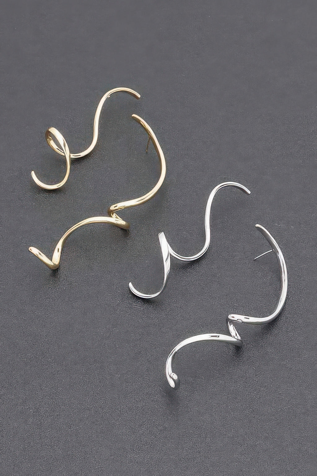 Set of gold and silver twist dangle earrings, curved open-hoop style