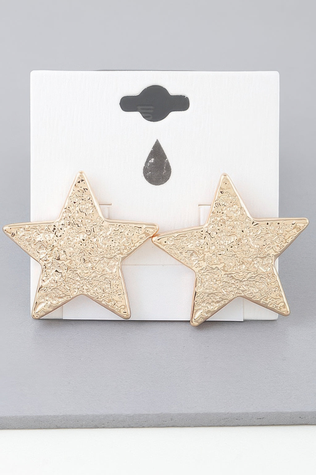 Gold hammered star earrings on display card, two stud stars with posts