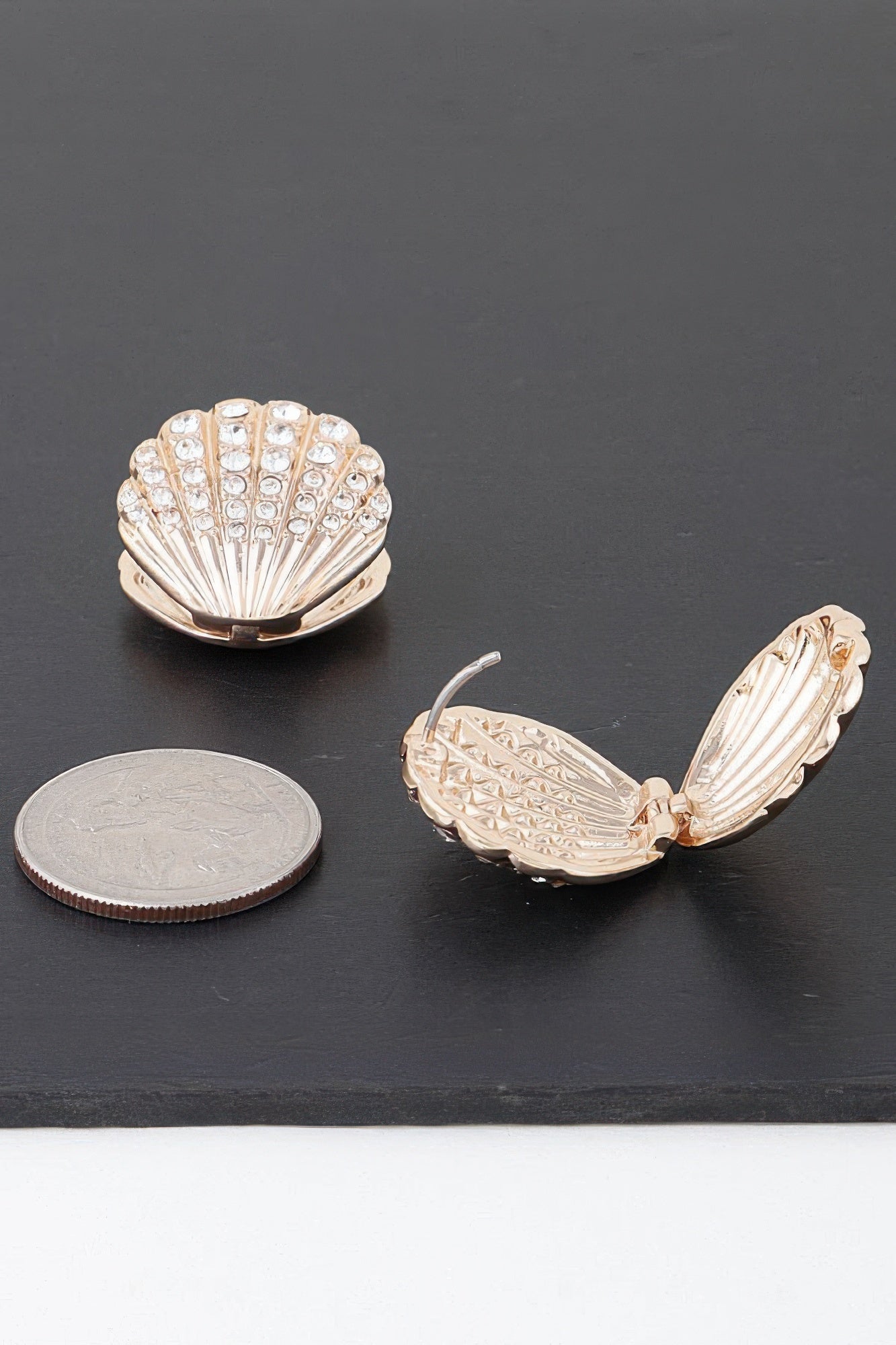 Jeweled clam shell earring with clear stones and gold-tone setting, side view