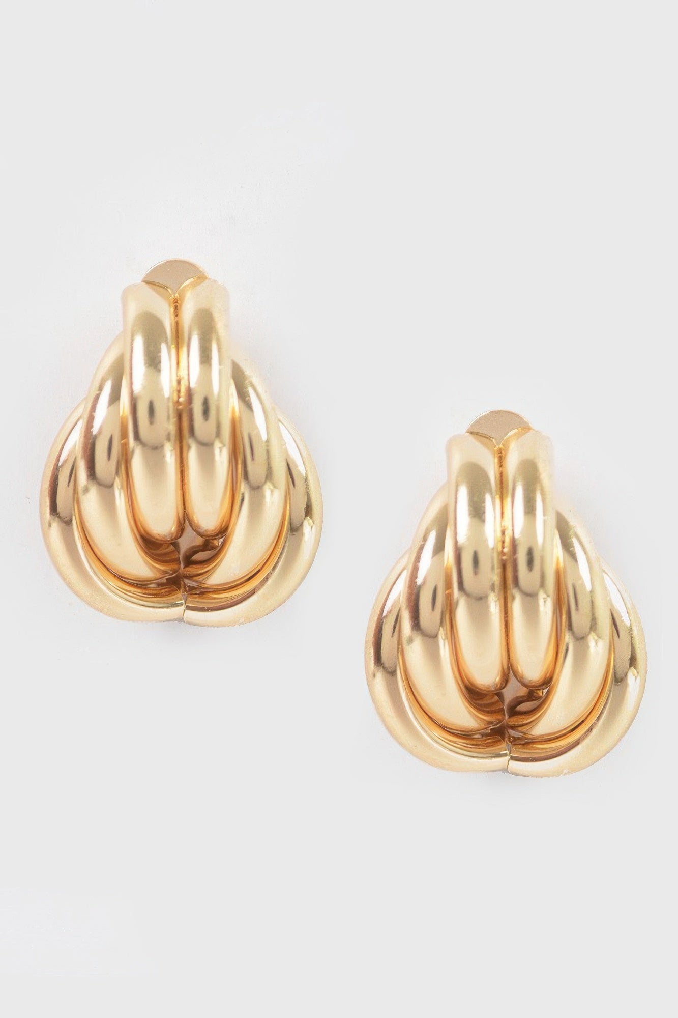Gold metal stud earrings, scalloped teardrop shell design, shiny finish
