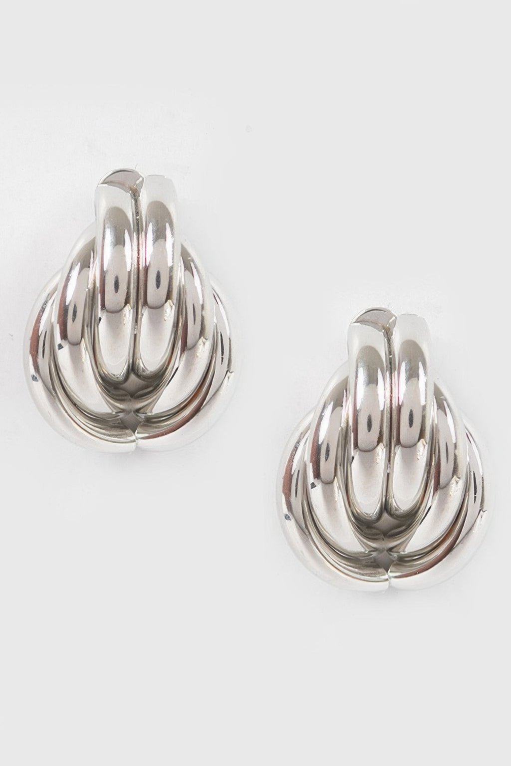 Silver metal stud earrings, scalloped teardrop swirl pattern, polished shine