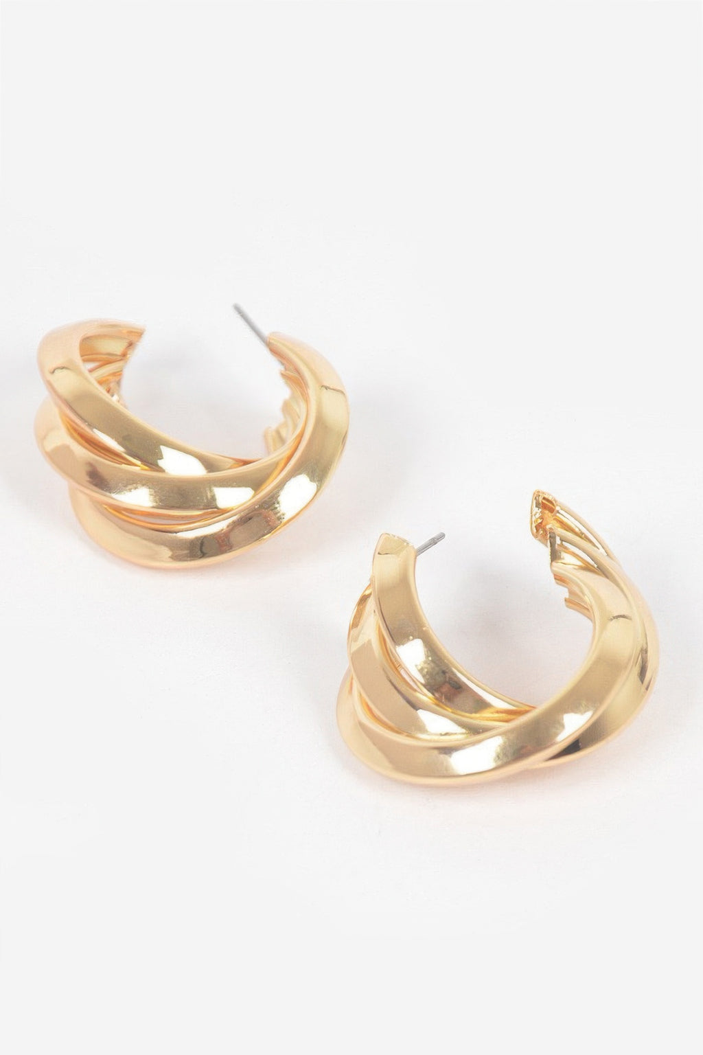 Small gold hoop earrings with stacked metal bands and stud backing