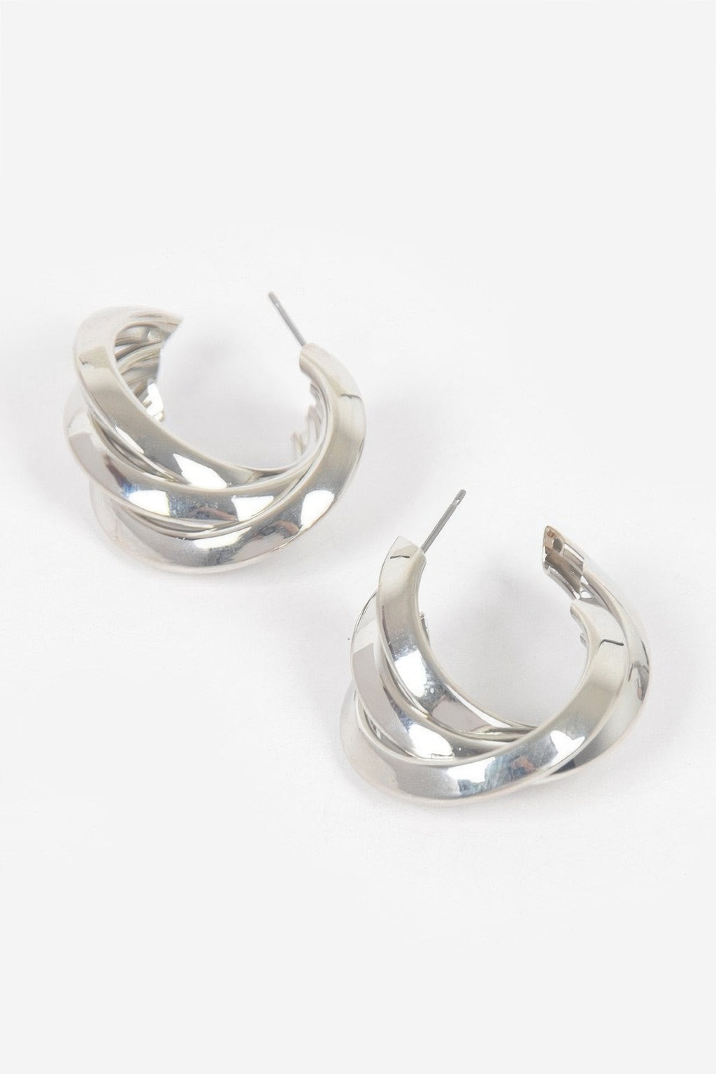 Small silver hoop earrings with layered metal bands and stud backing