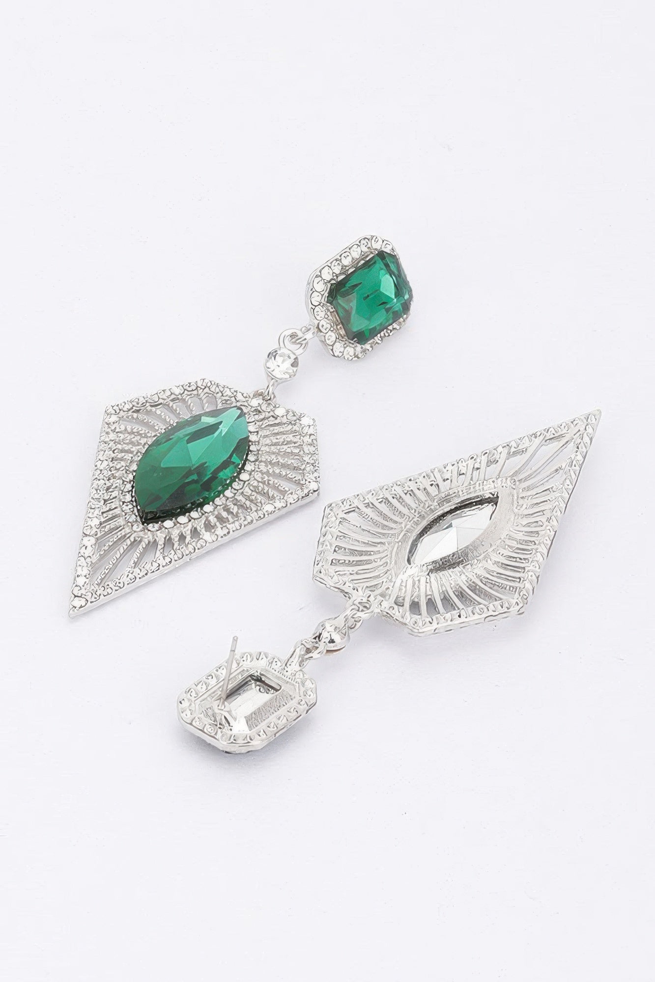 Green rhinestone earrings with emerald-toned oval stones and geometric silver drops