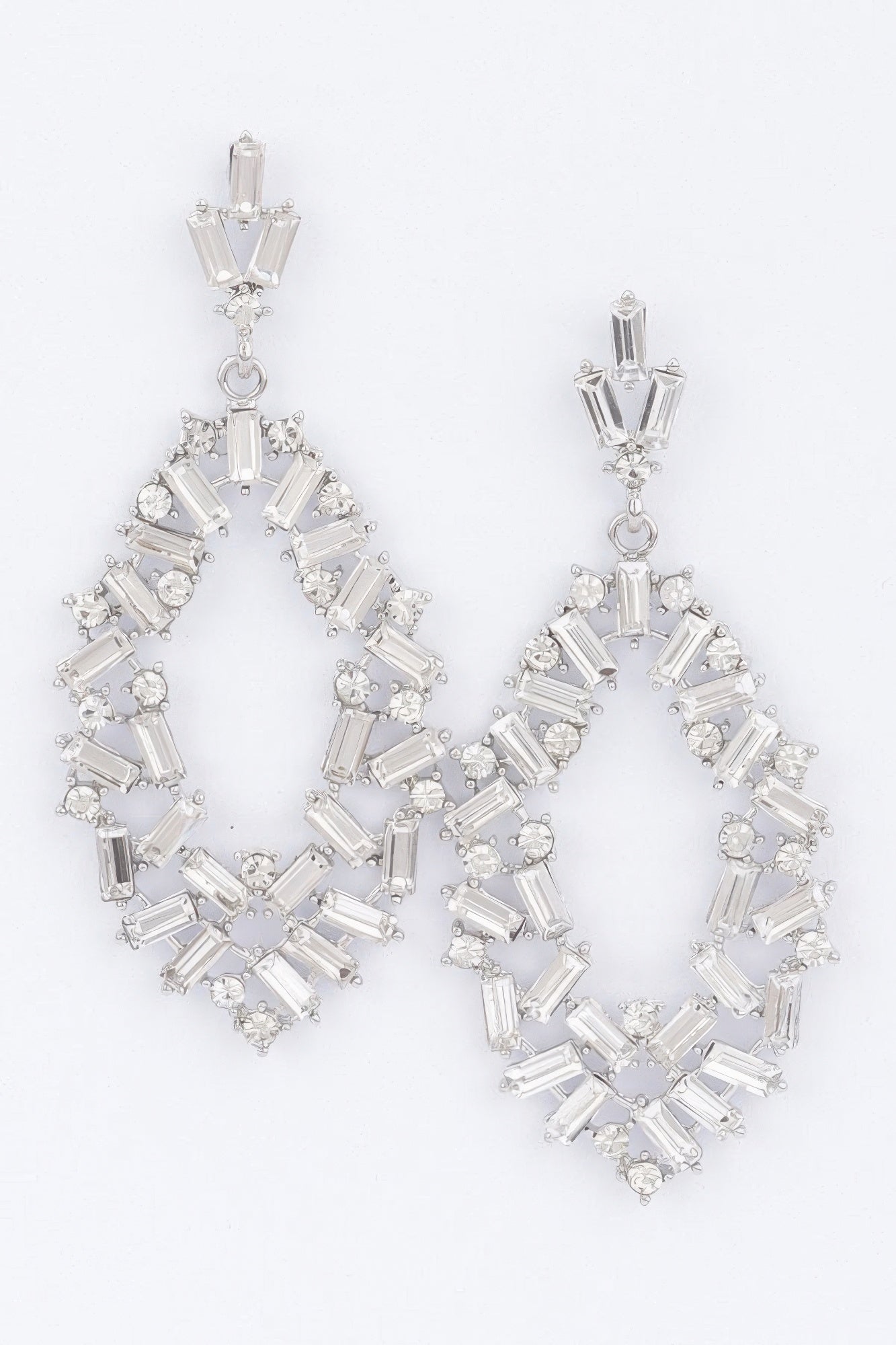 Silver rhinestone hoop earrings with baguette stones and dangling charm
