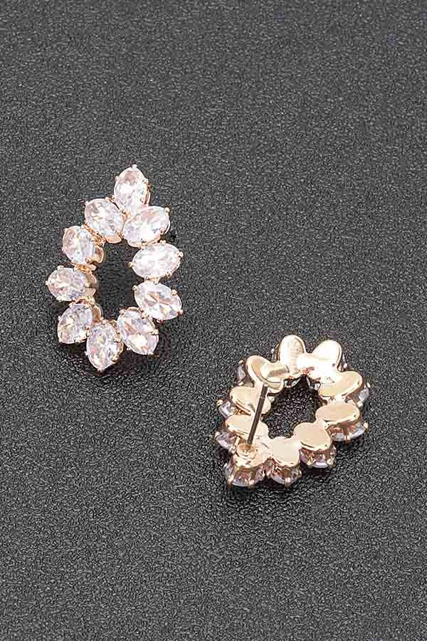 Gold-tone rhinestone hoop earrings with oval clear stones and visible backing/loop.