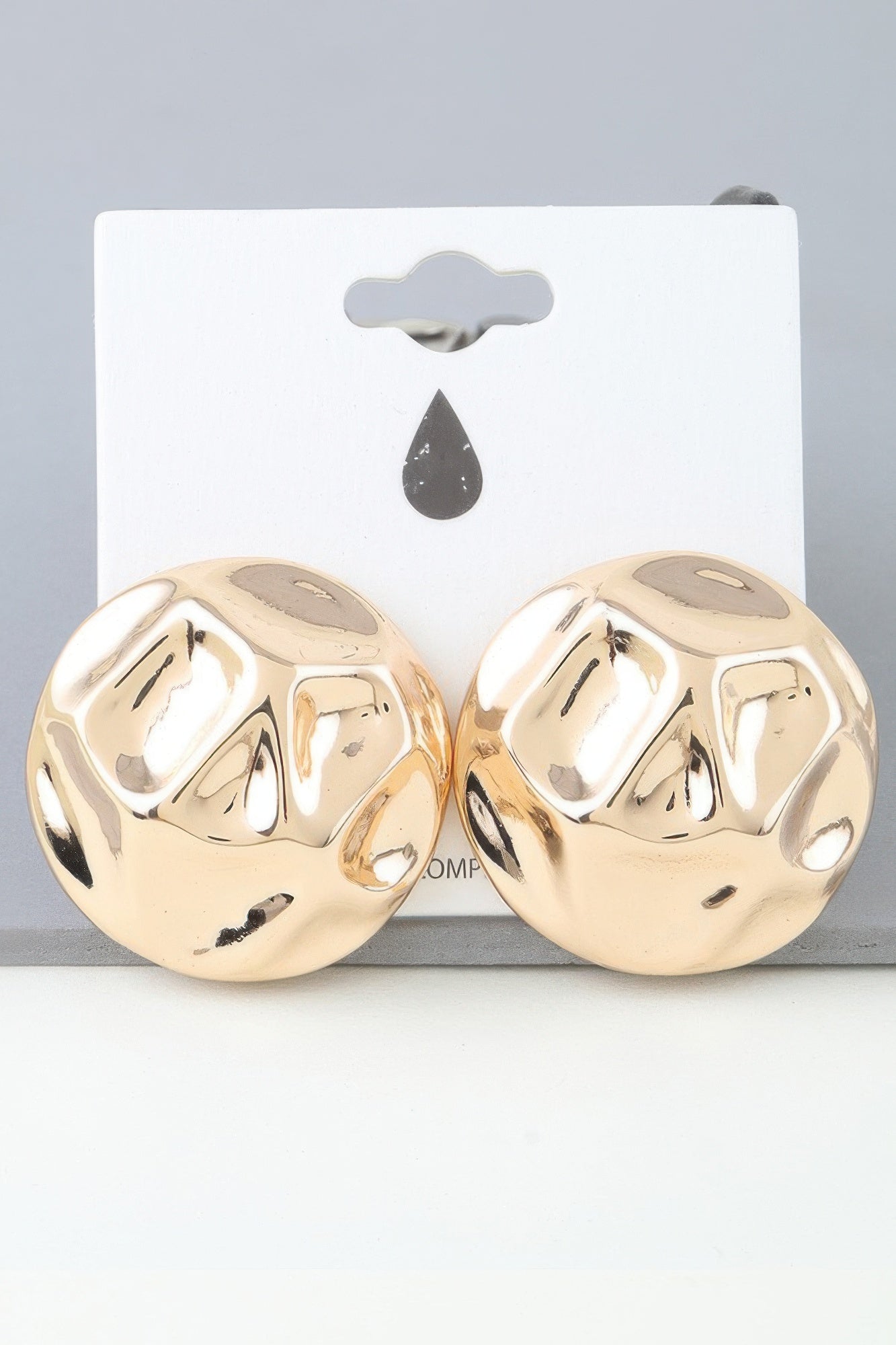 Gold tone hammered dome earrings, stud pair on card backing