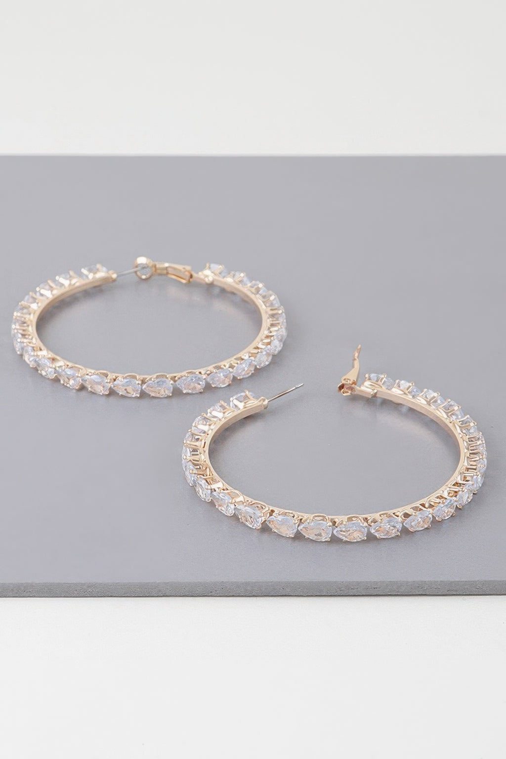 Teardrop jeweled hoop earrings, gold-tone with clear faceted stones