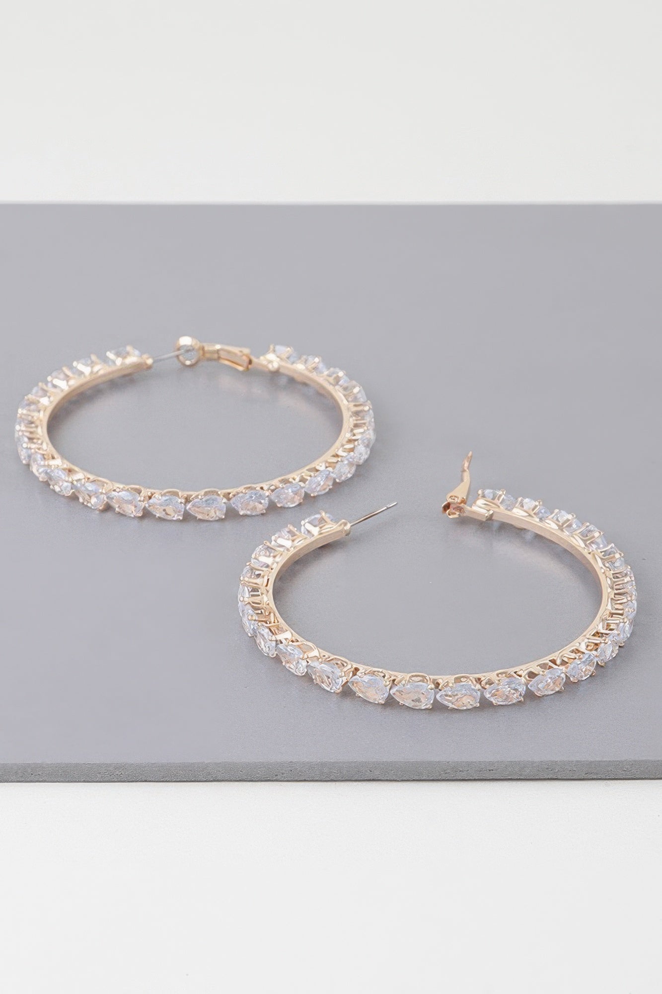 Teardrop jeweled hoop earrings, gold-tone with clear faceted stones