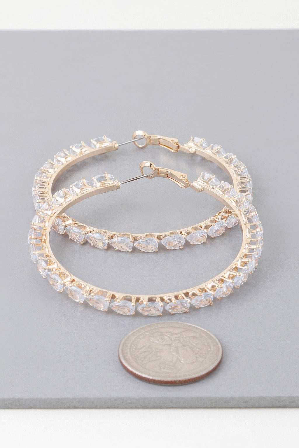 Teardrop jeweled hoop earrings, gold-tone hinged hoops with clear stones