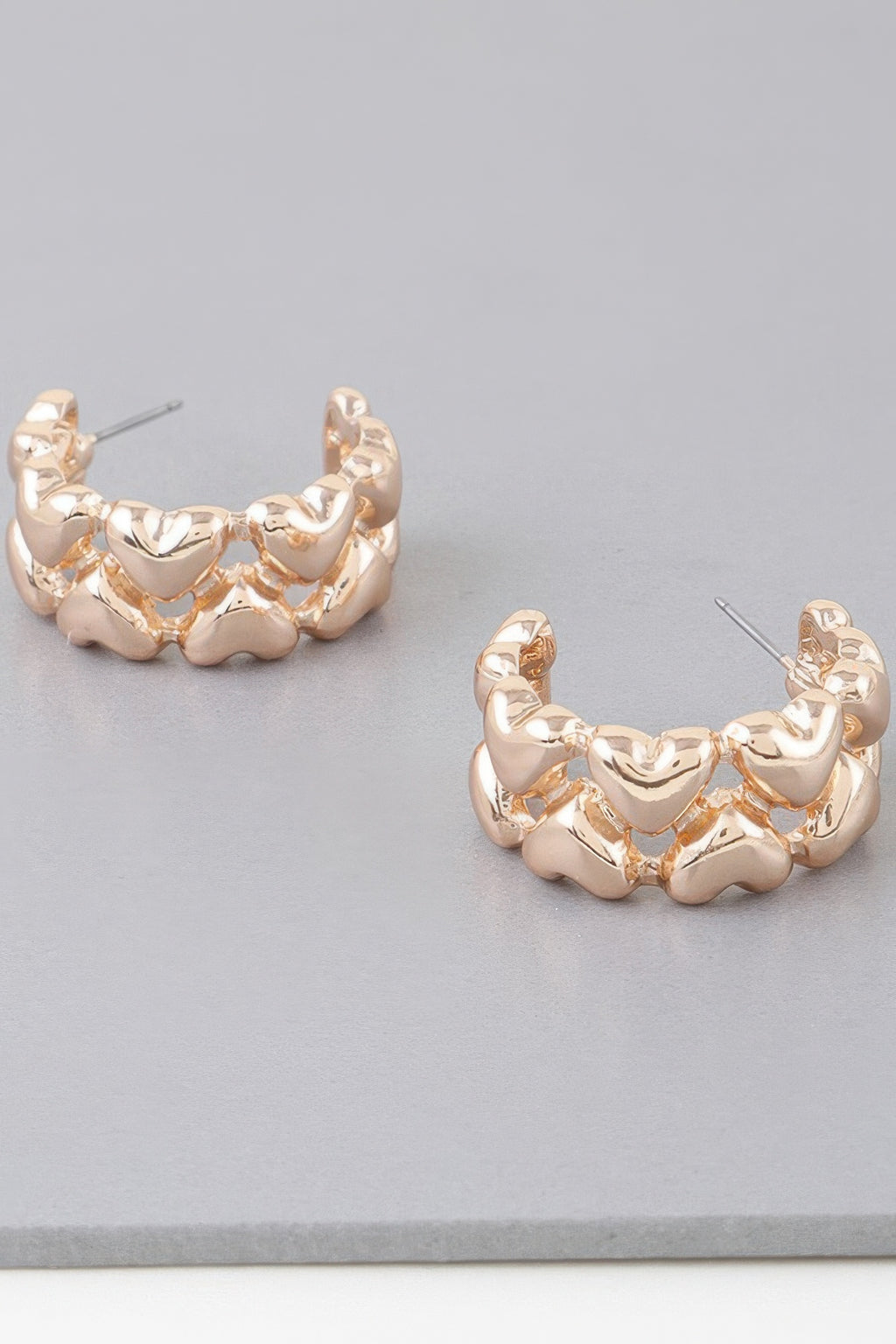 Gold-tone twin-heart hoop earrings with ridged scalloped heart links
