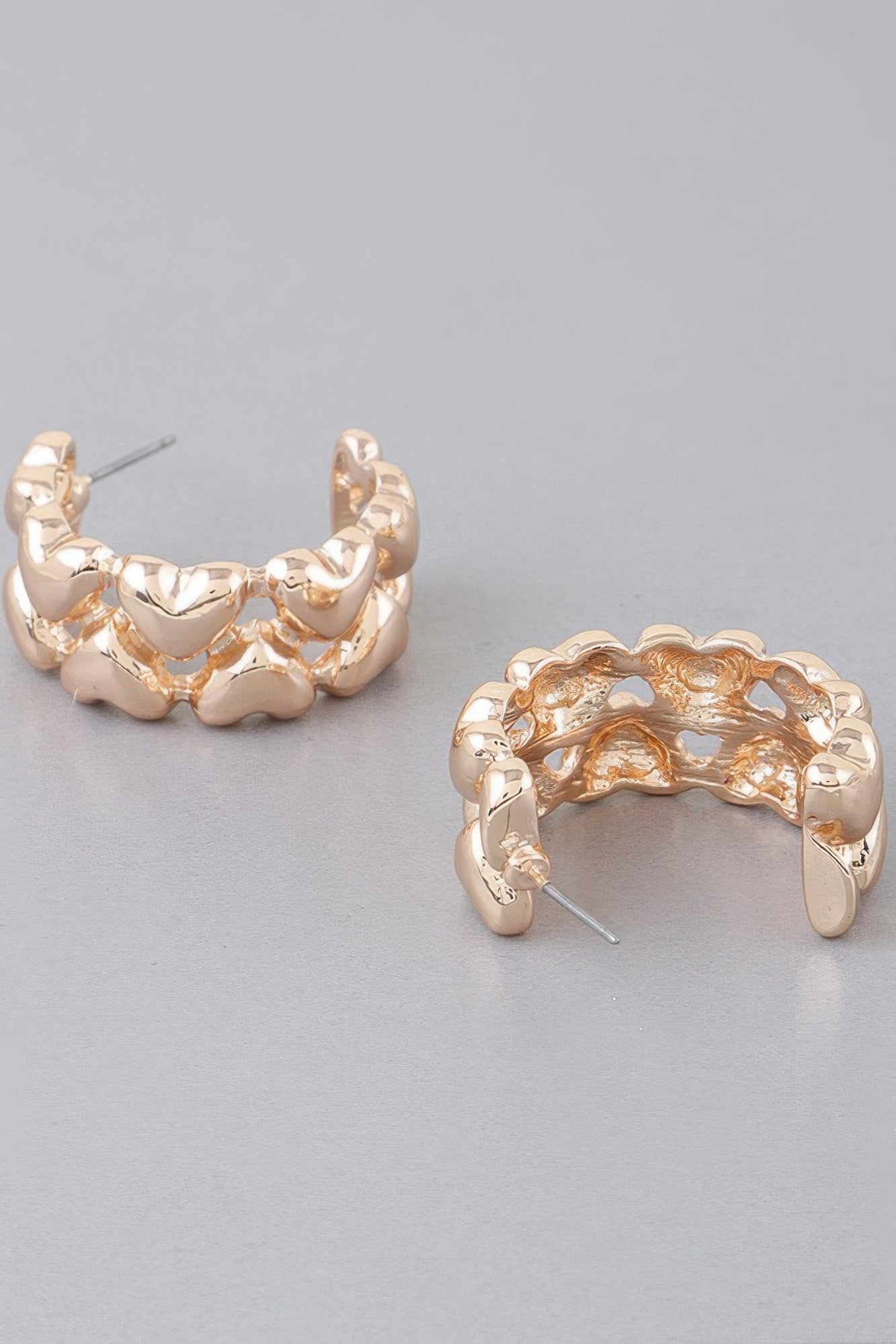 Gold-tone hoop earrings, side view, heart-shaped scalloped band with stud post