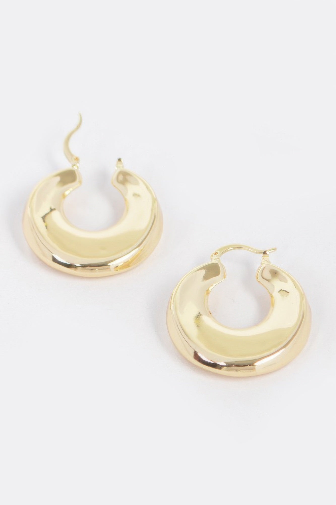 Vintage gold dip hoop metal earrings, curved crescent shape, shiny finish