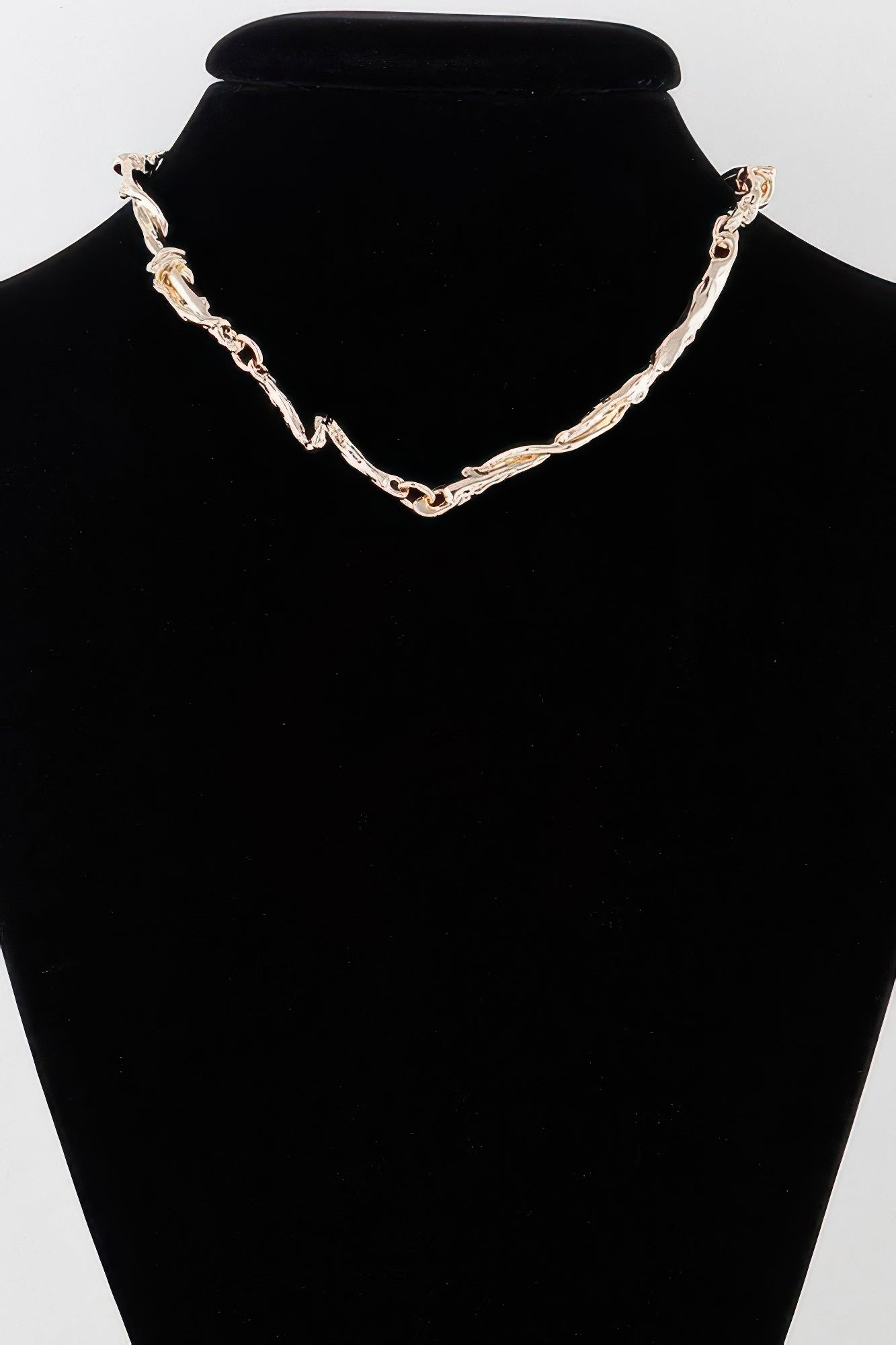 Gold multi-twisted abstract necklace with linked chain and curved pendant links