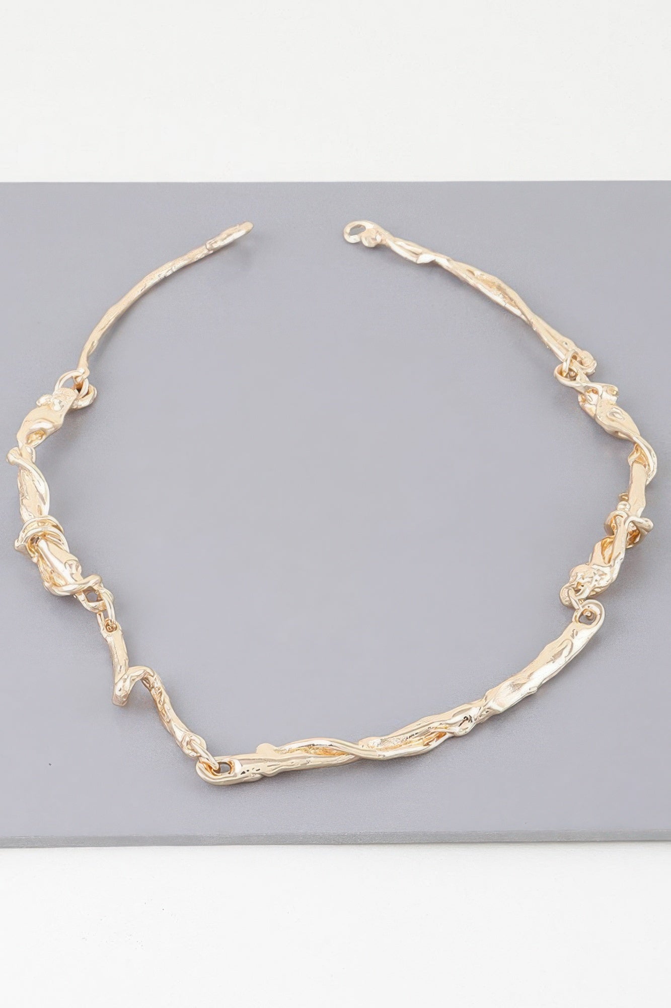 Gold multi-twisted abstract necklace, oval chain with ornate textured links