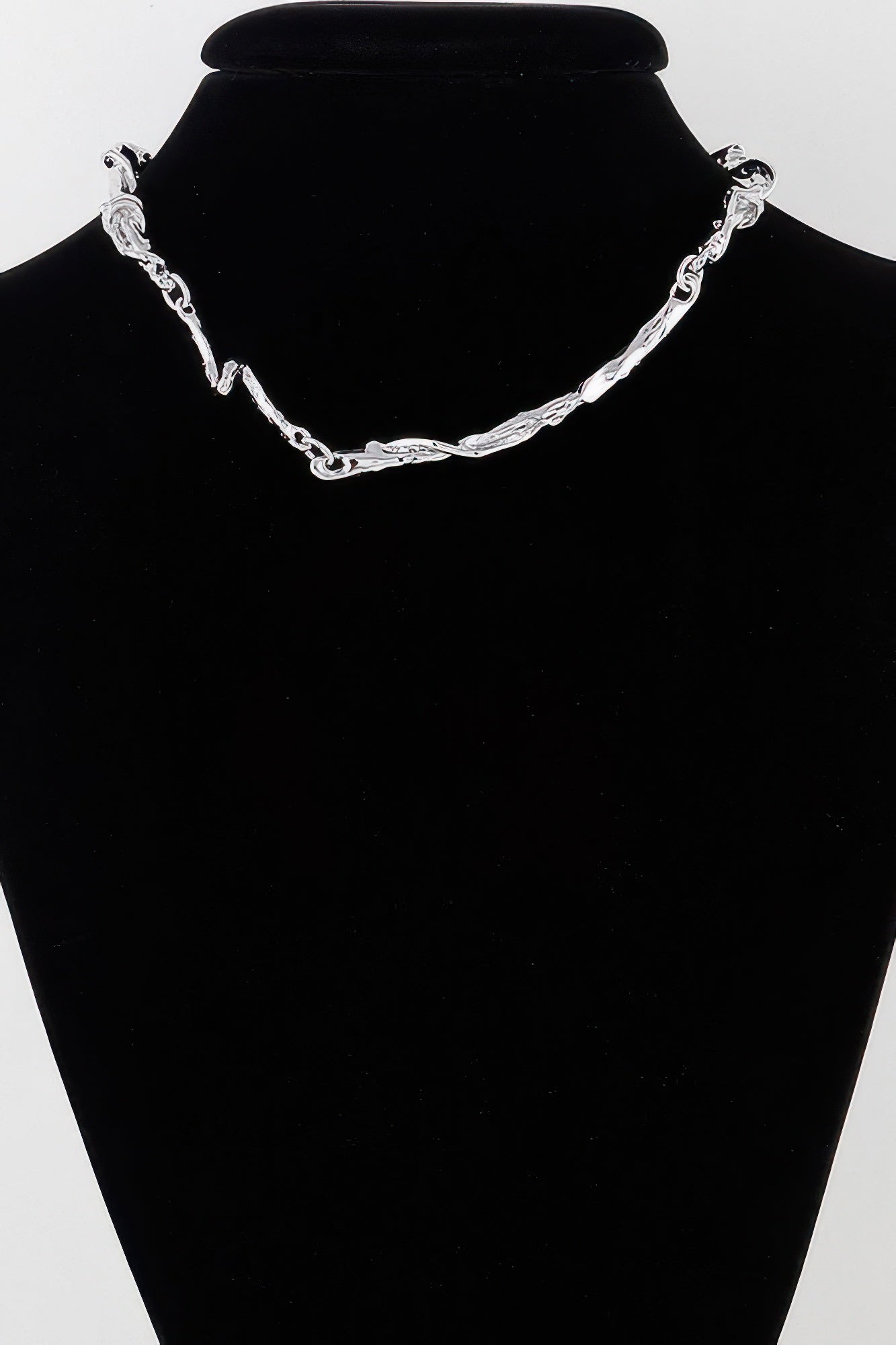 Silver multi-twisted abstract necklace with interlinked chain and wavy pendant bars