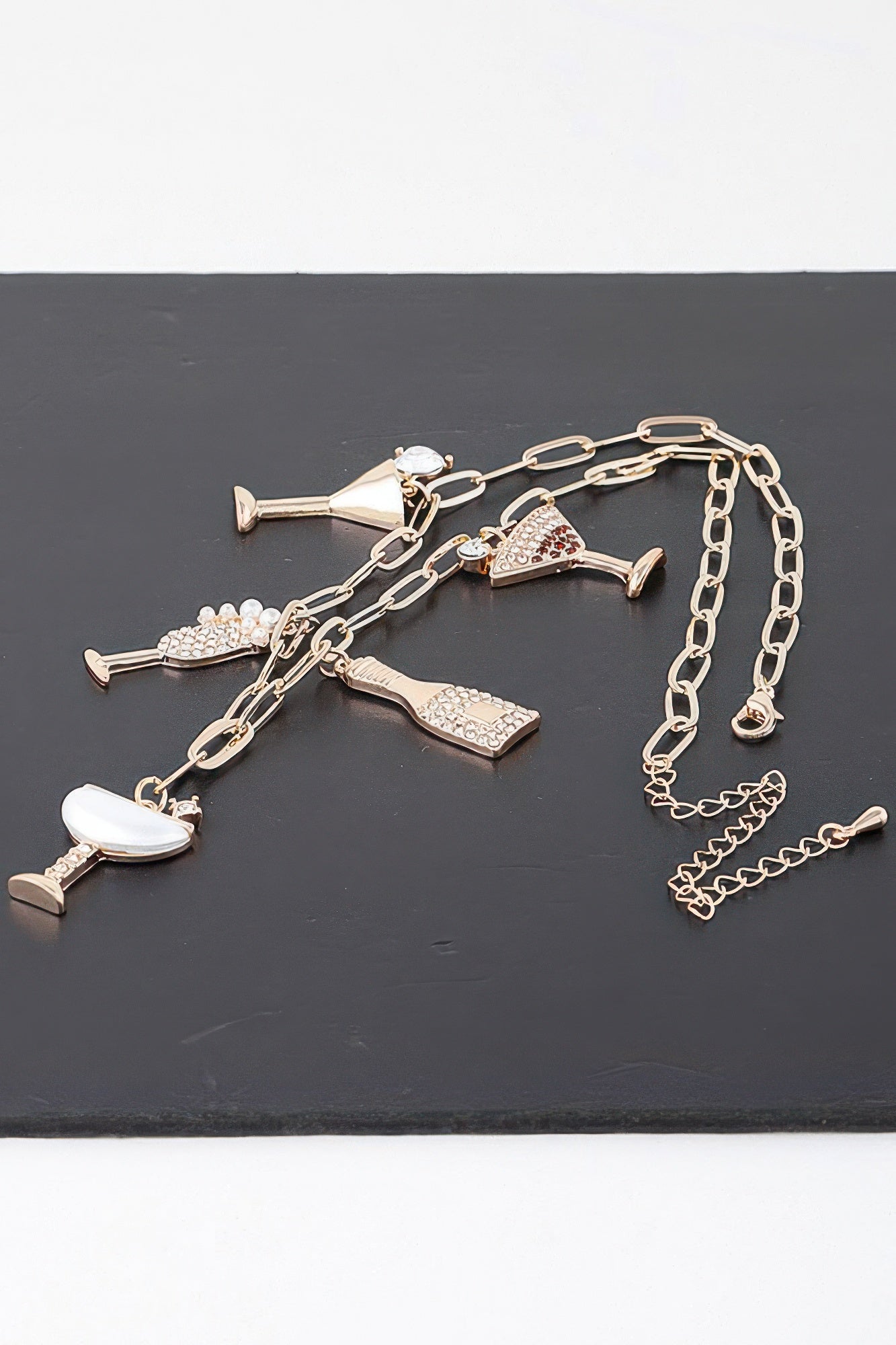Gold-clear party drinks charm necklace with multiple drink-shaped charms and long chain
