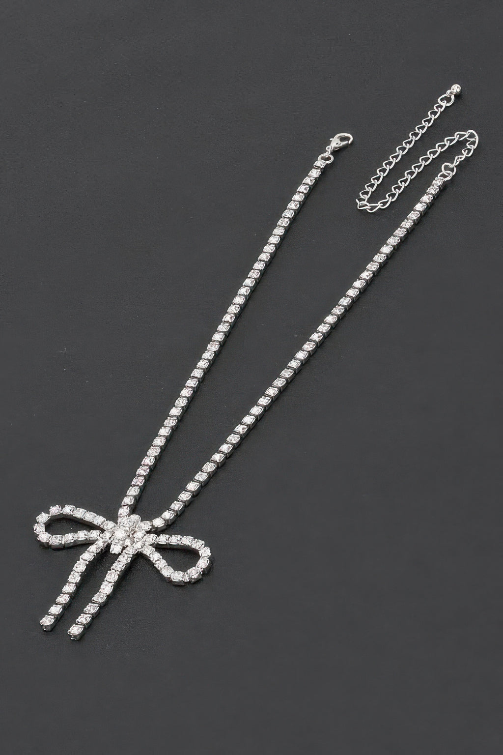 Rhinestone bow necklace with long rhinestone chain and silver-clear bow pendant