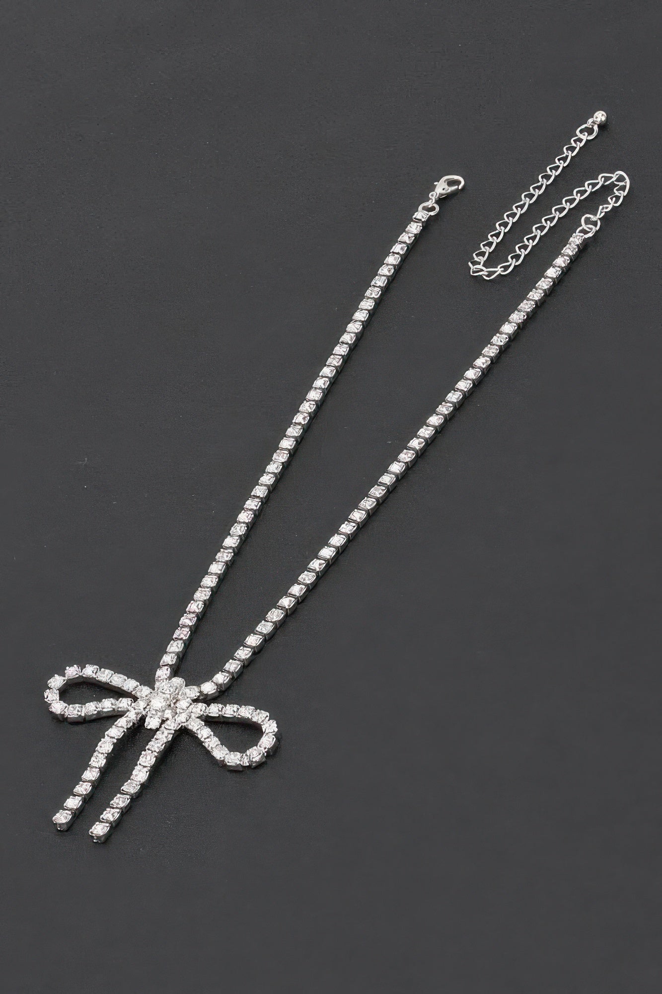 Rhinestone bow necklace with long rhinestone chain and silver-clear bow pendant