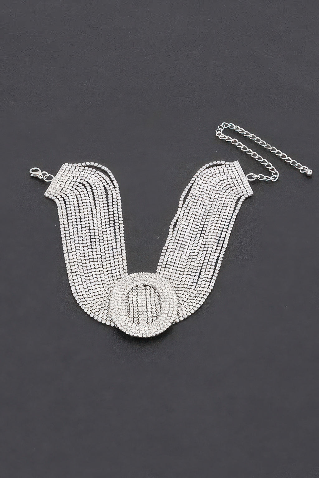 Rhinestone choker necklace laid flat, wide band with oval clasp and connecting chain