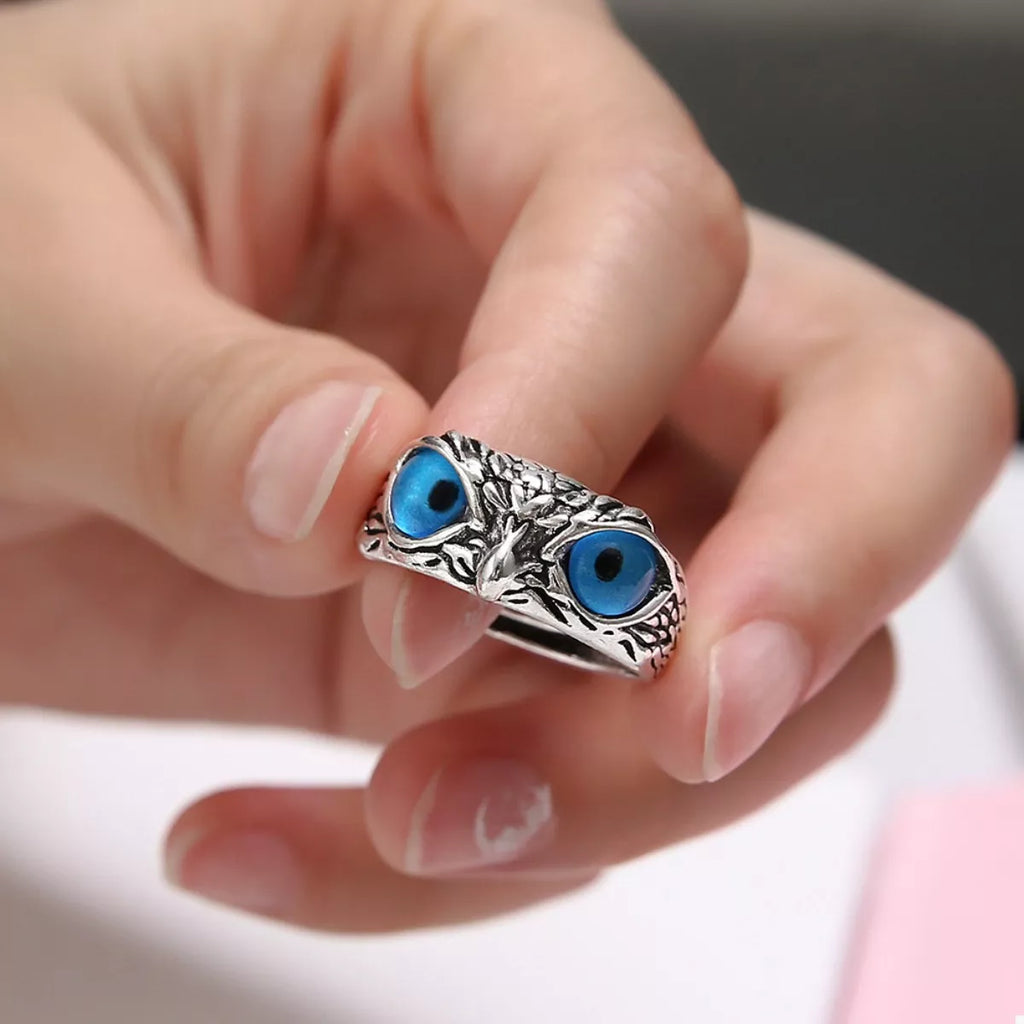 Silver owl eyes ring worn on finger, blue eye cabochons with textured metal band