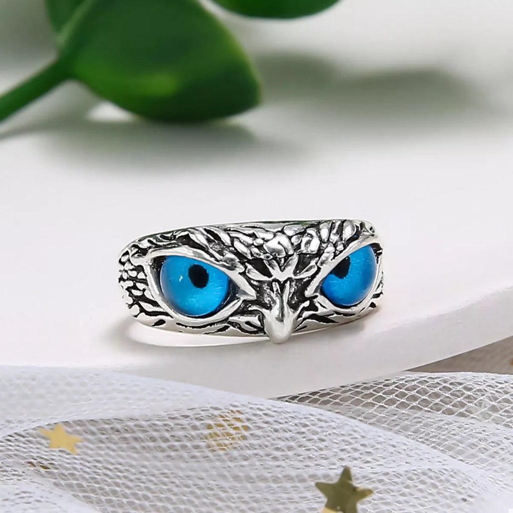 Silver owl eyes ring side view with two blue eye cabochons and tree-branch motif
