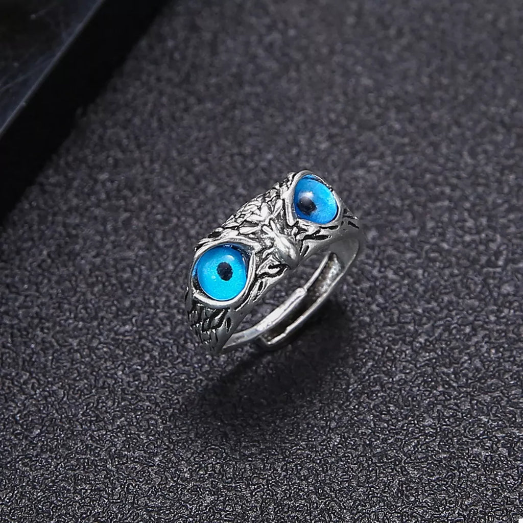 Silver owl eyes ring showing one blue eye cabochon and detailed silver texture