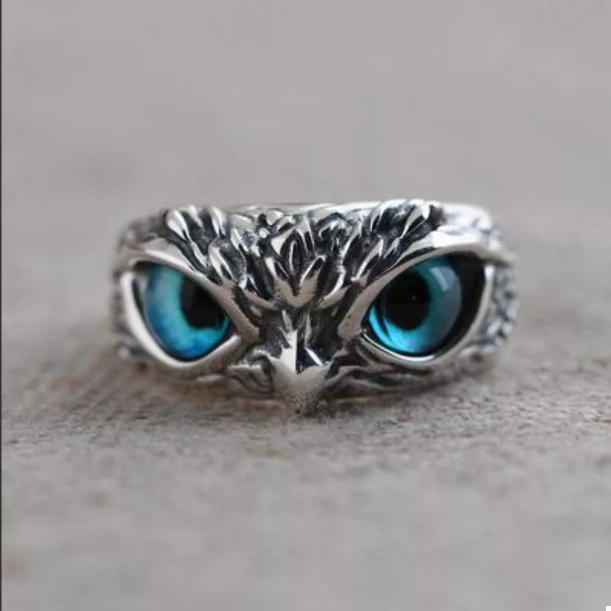 Silver owl eyes ring, front view with blue eye inlays and branching metal design