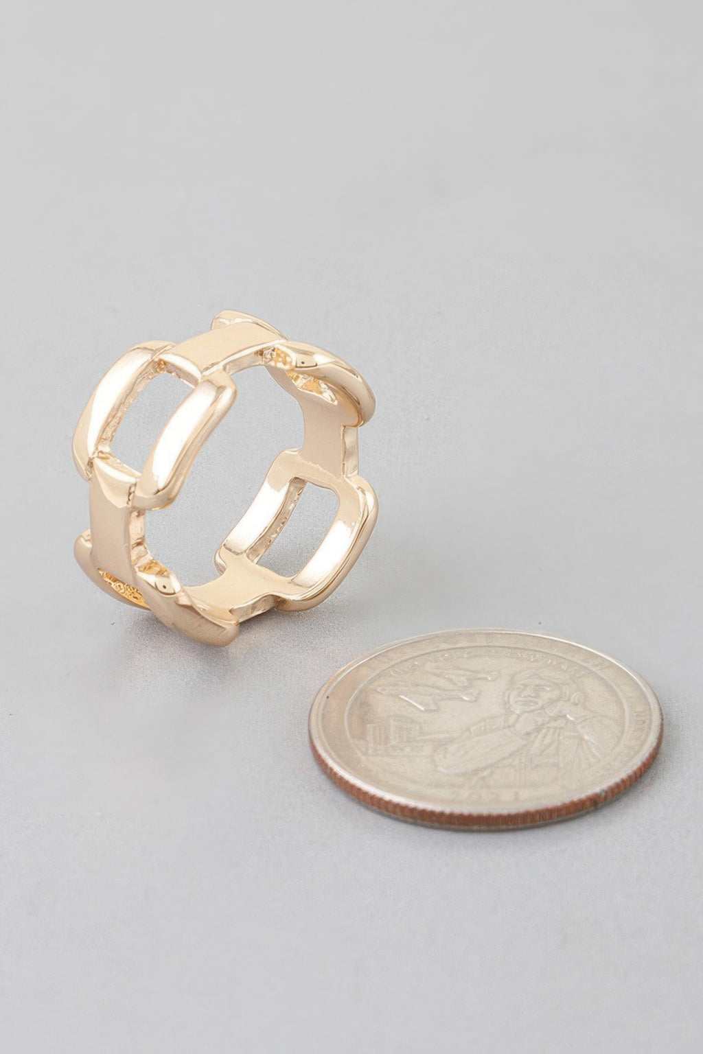 Gold-tone shiny link chain ring, close-up of open square link band
