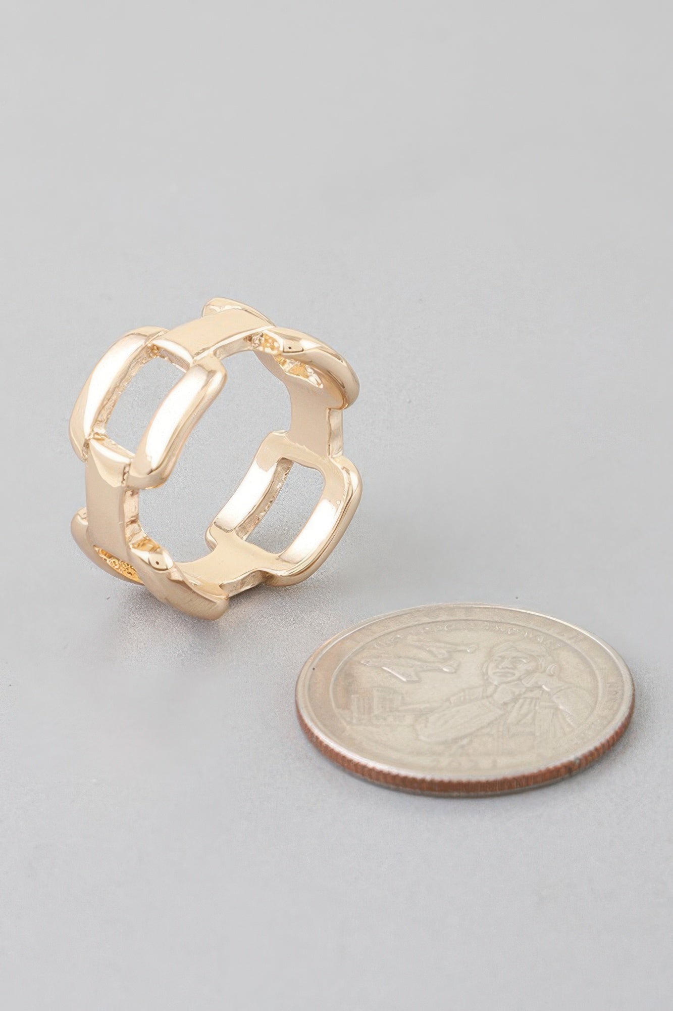 Gold-tone shiny link chain ring, close-up of open square link band