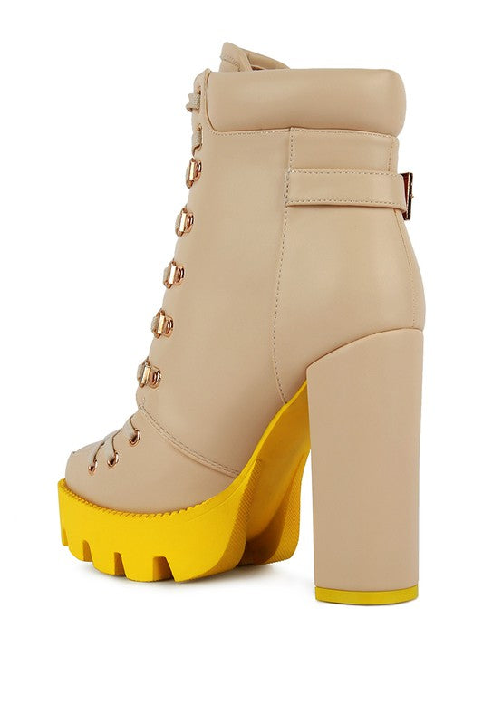 Beige lace-up biker boot with buckle straps and chunky yellow platform heel