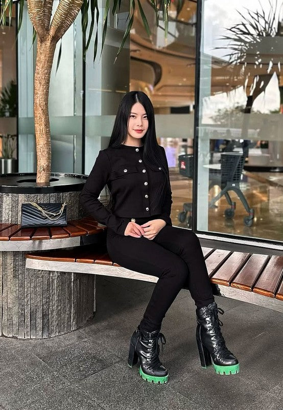 Black lace-up biker boots with green platform sole